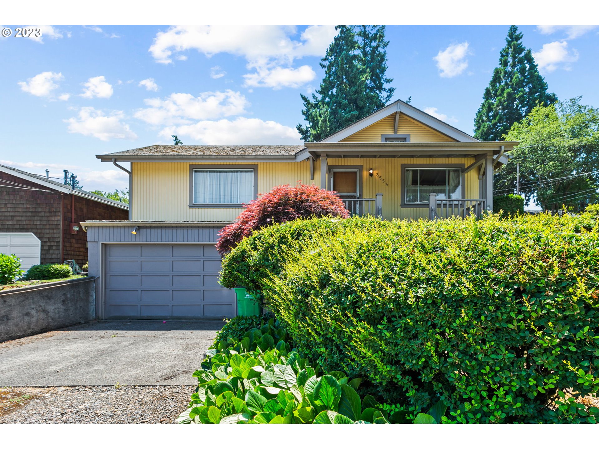 3554 Southwest Falcon Street Portland, OR 97219 - Photo 23 of 23 a front view of a house with a garden