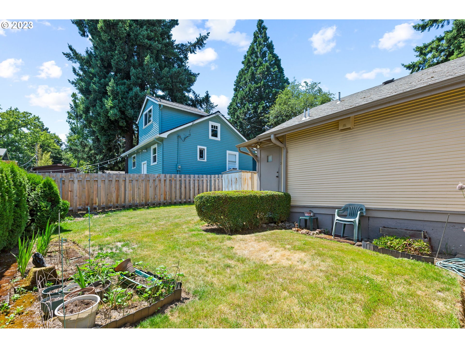 3554 Southwest Falcon Street Portland, OR 97219 - Photo 7 of 23 a view of backyard with wooden fence and large trees