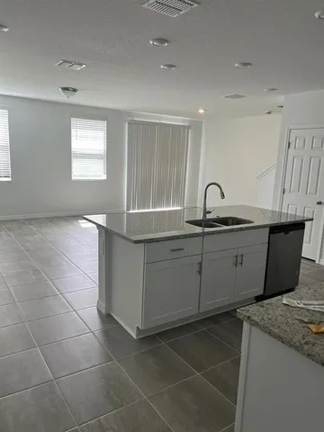 a kitchen with a sink cabinets and window