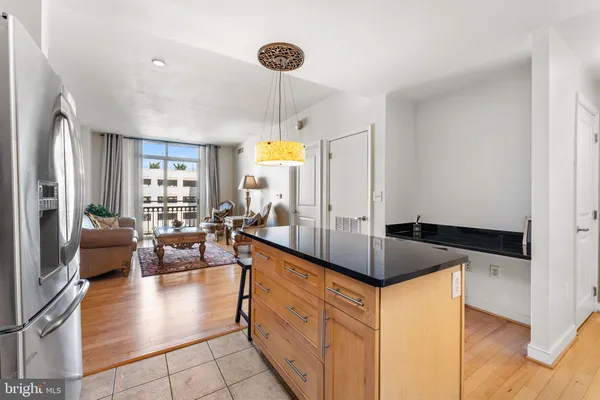a kitchen with stainless steel appliances granite countertop a sink and a refrigerator