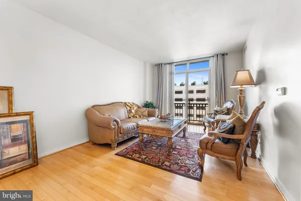 a living room with furniture a lamp and a window