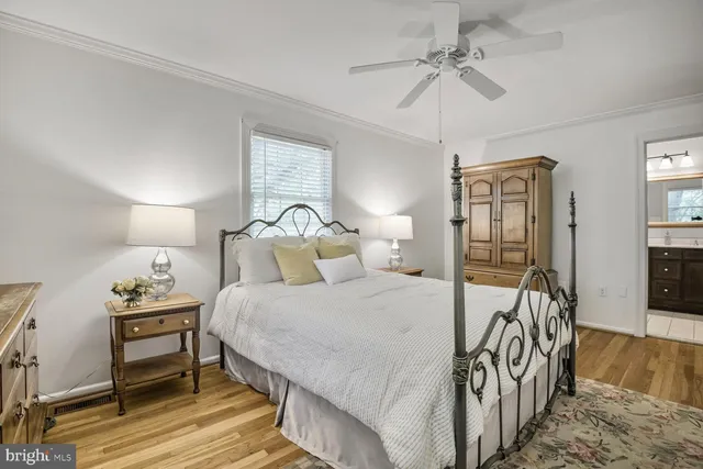a spacious bedroom with a bed and a chandelier