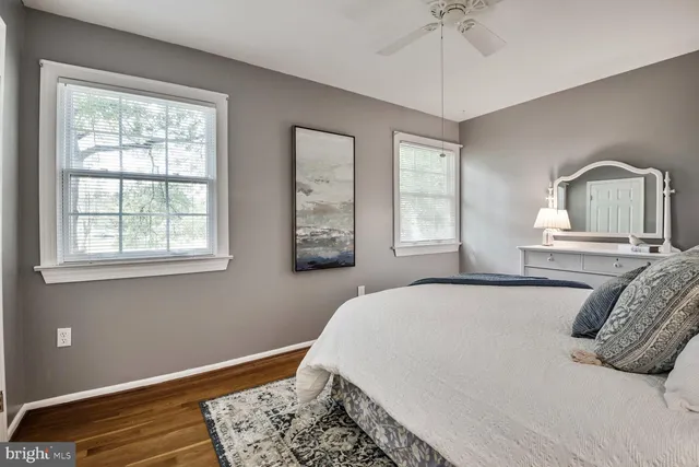 a bedroom with a large bed and wooden floor