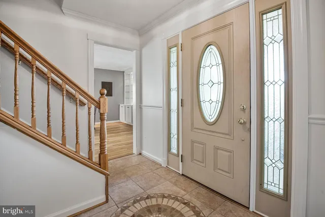 a view of a livingroom with wooden floor furniture and a kitchen