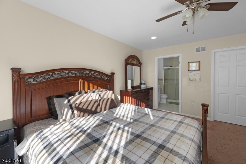 158 Autumn Ridge Road Morris Plains, NJ 07950 - Photo 25 of 26 a bedroom with a bed and a mirror