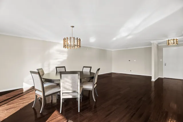 a view of a dining room with furniture and chandelier