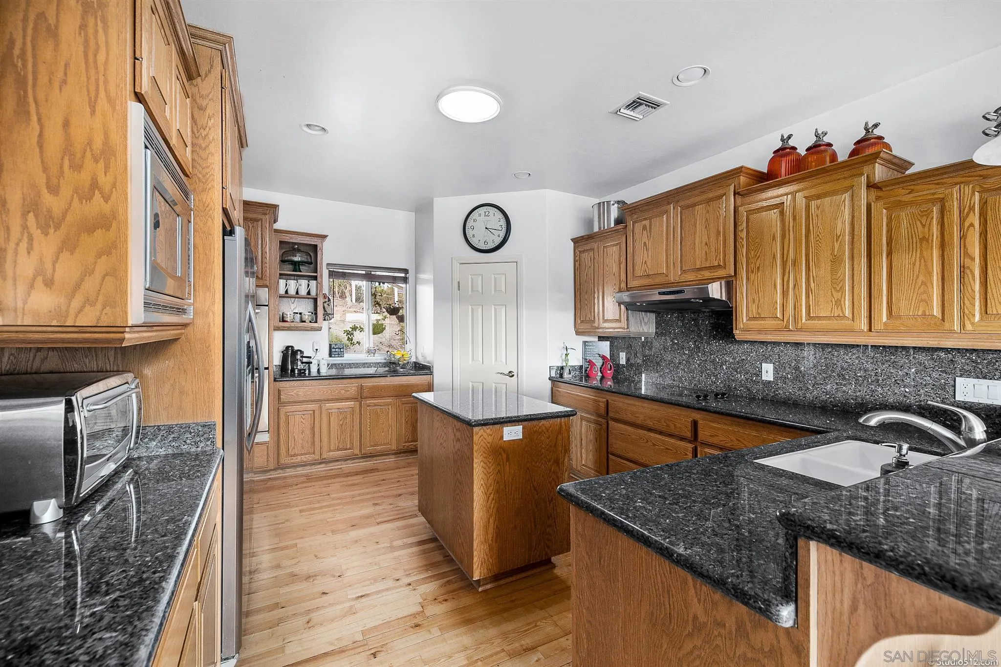 31011 Saddleback Road Valley Center, CA 92082 - Photo 8 of 30 a kitchen that has a lot of cabinets in it