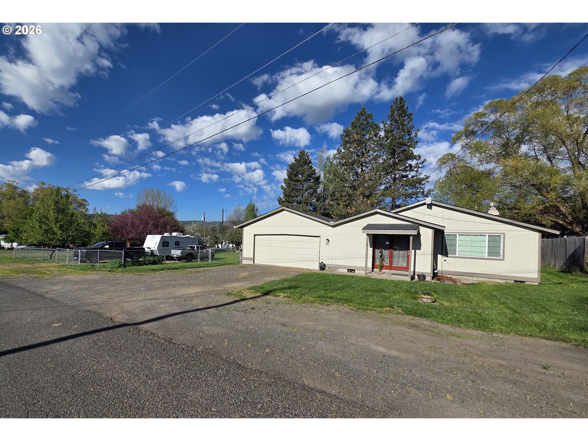 740 North 11th Street Elgin, OR 97827 - Photo 1 of 20 a front view of a house with a yard and garage