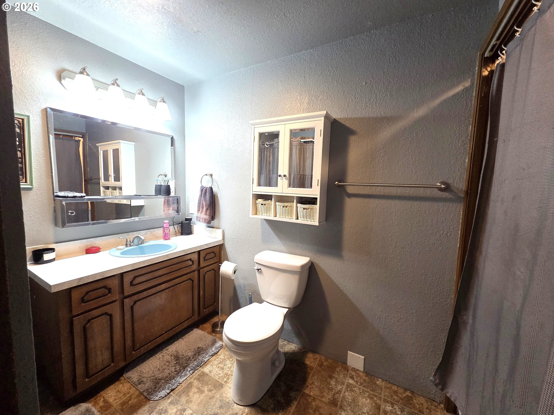 740 North 11th Street Elgin, OR 97827 - Photo 11 of 20 a bathroom with a toilet sink and mirror