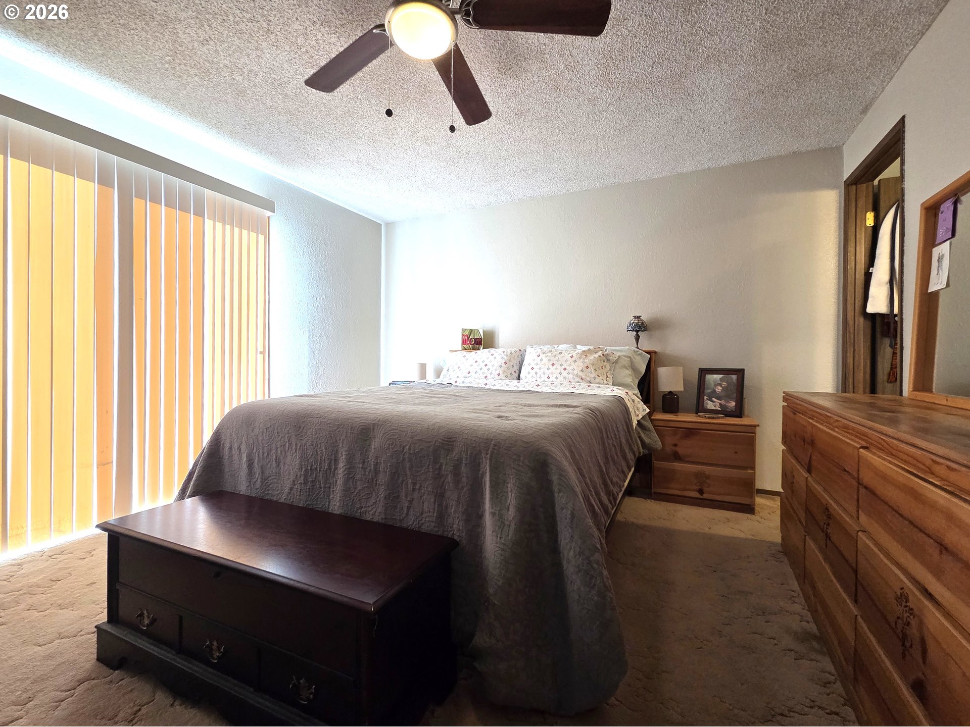 740 North 11th Street Elgin, OR 97827 - Photo 12 of 20 a bedroom with a bed lamps and window