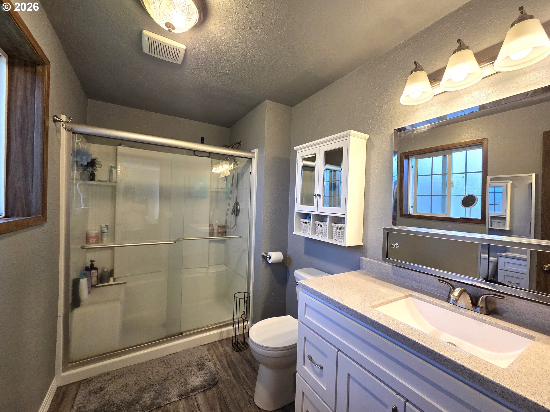 740 North 11th Street Elgin, OR 97827 - Photo 13 of 20 a bathroom with a granite countertop toilet sink and shower