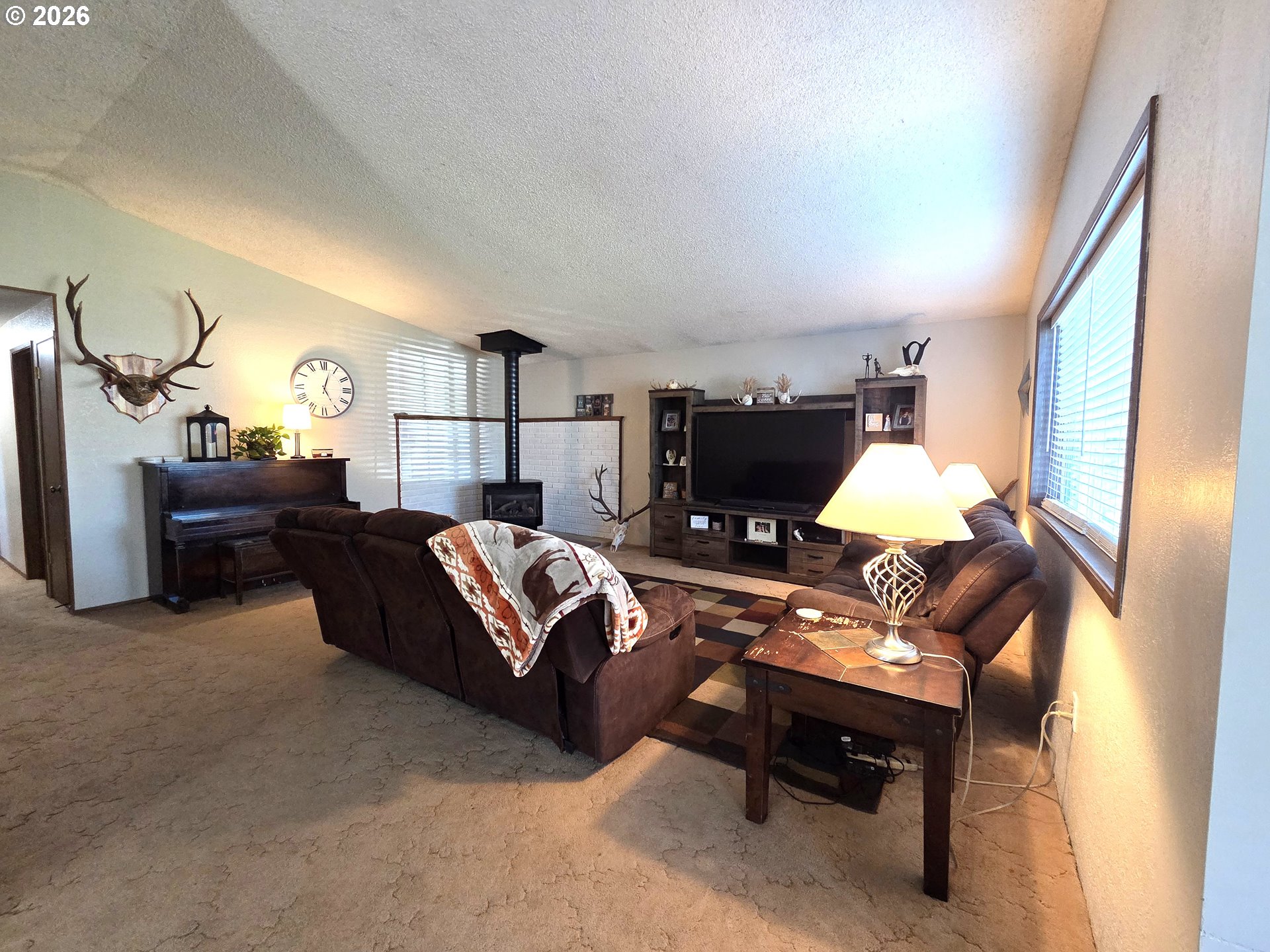 740 North 11th Street Elgin, OR 97827 - Photo 2 of 20 a living room with furniture fireplace and a flat screen tv