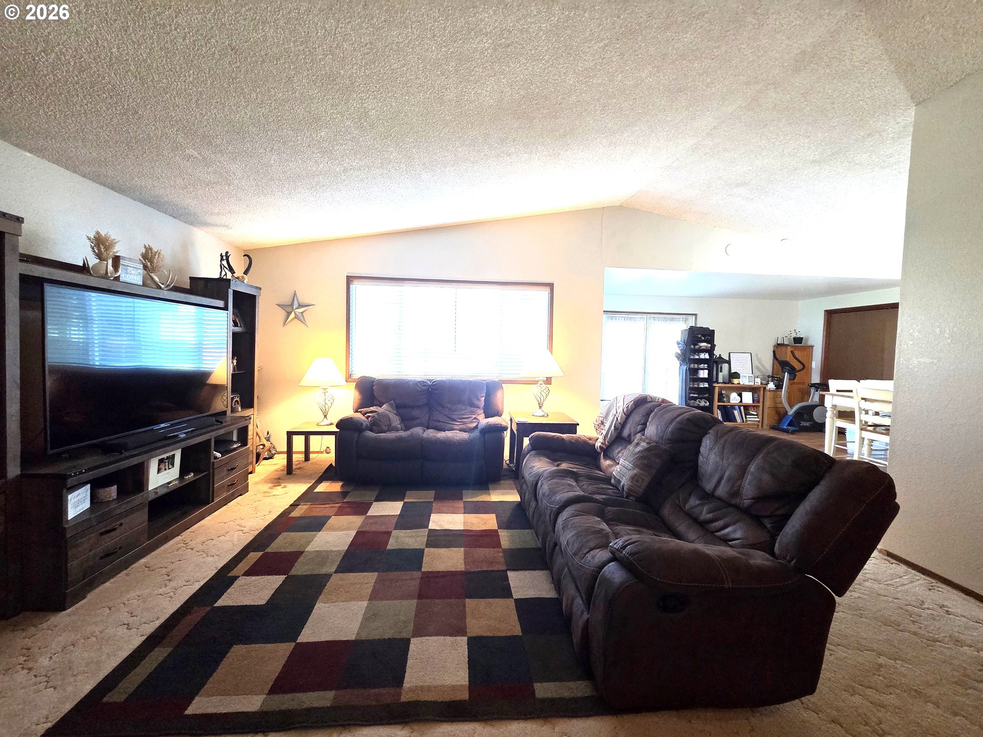 740 North 11th Street Elgin, OR 97827 - Photo 3 of 20 a living room with furniture and a flat screen tv