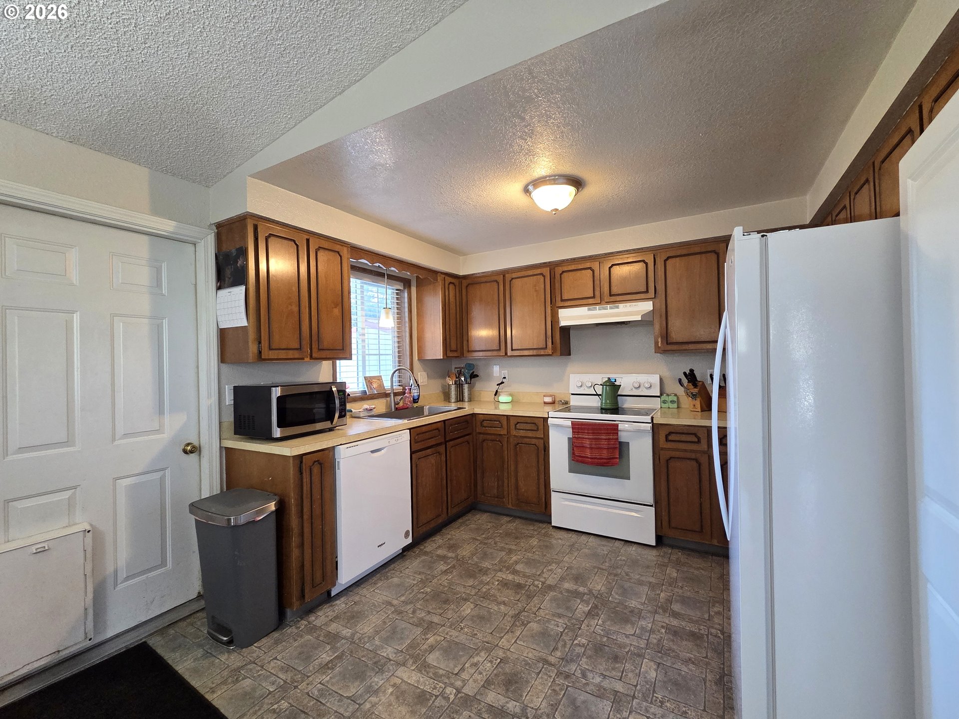 740 North 11th Street Elgin, OR 97827 - Photo 4 of 20 a kitchen with a refrigerator sink and stove top oven
