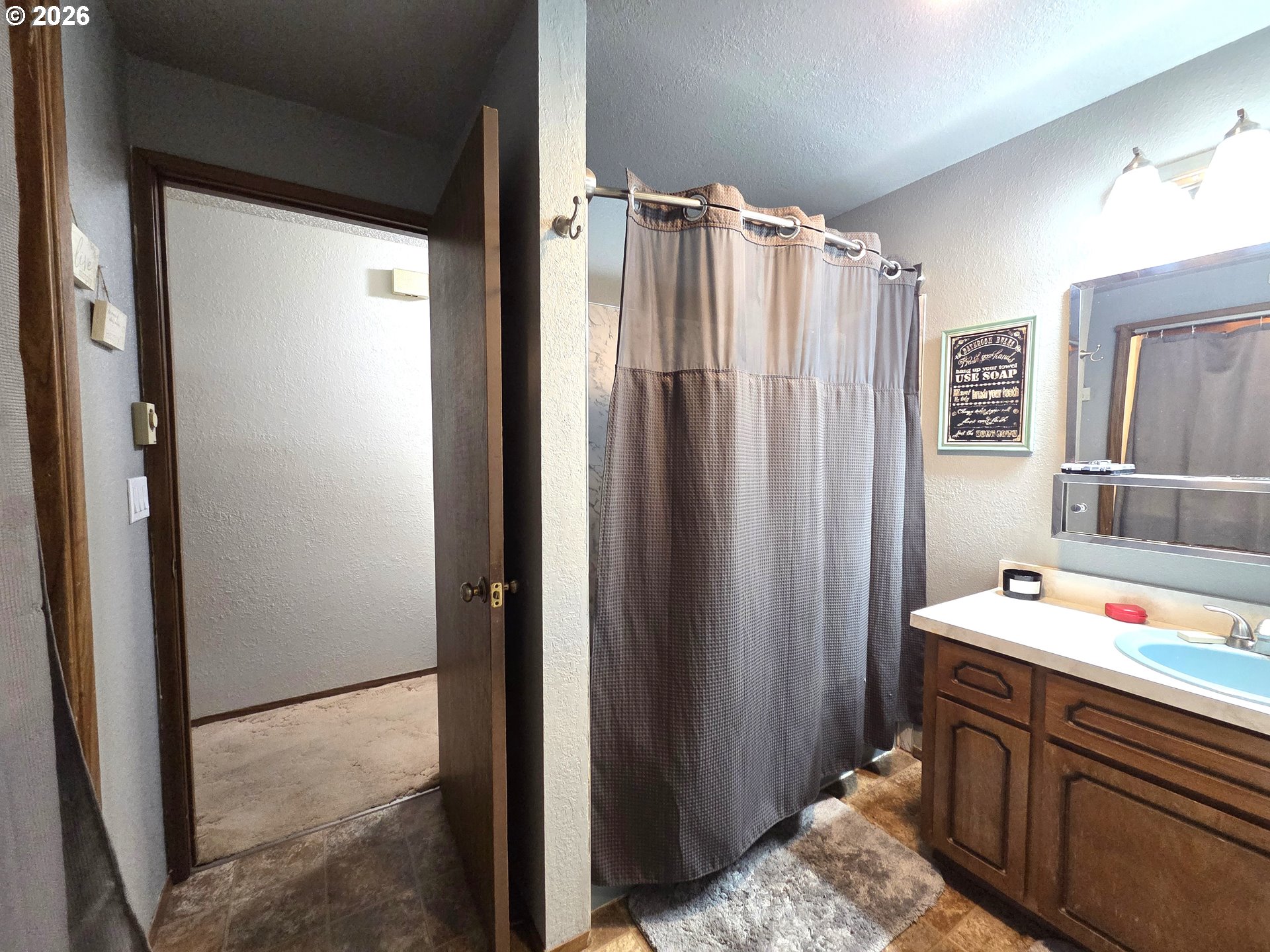 740 North 11th Street Elgin, OR 97827 - Photo 10 of 20 a bathroom with a sink vanity and a mirror