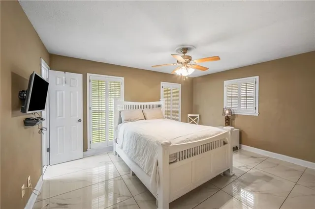 a bedroom with a large bed and a flat screen tv