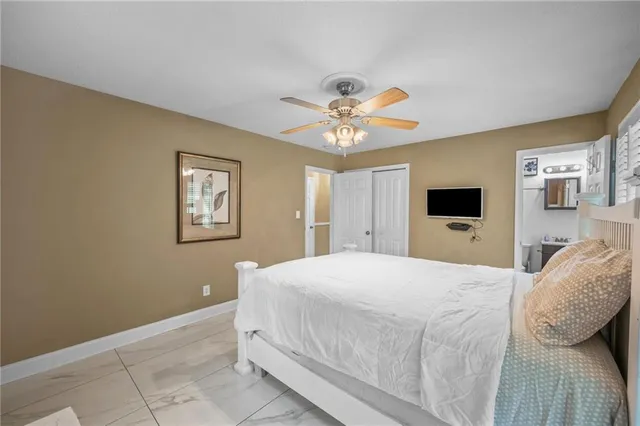 a spacious bedroom with a bed and a chandelier