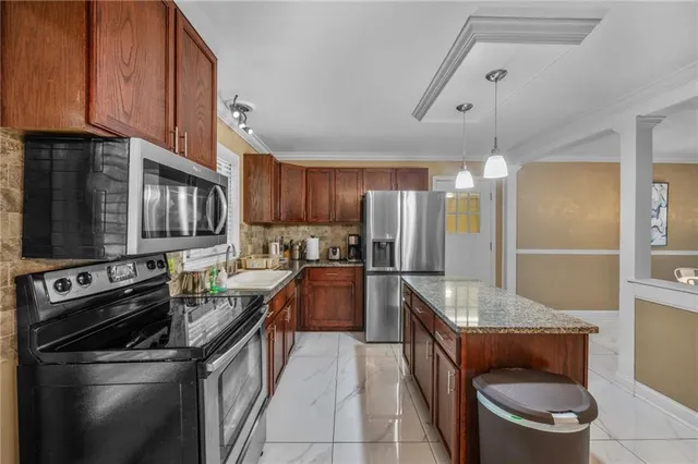 a kitchen with a sink stove and refrigerator