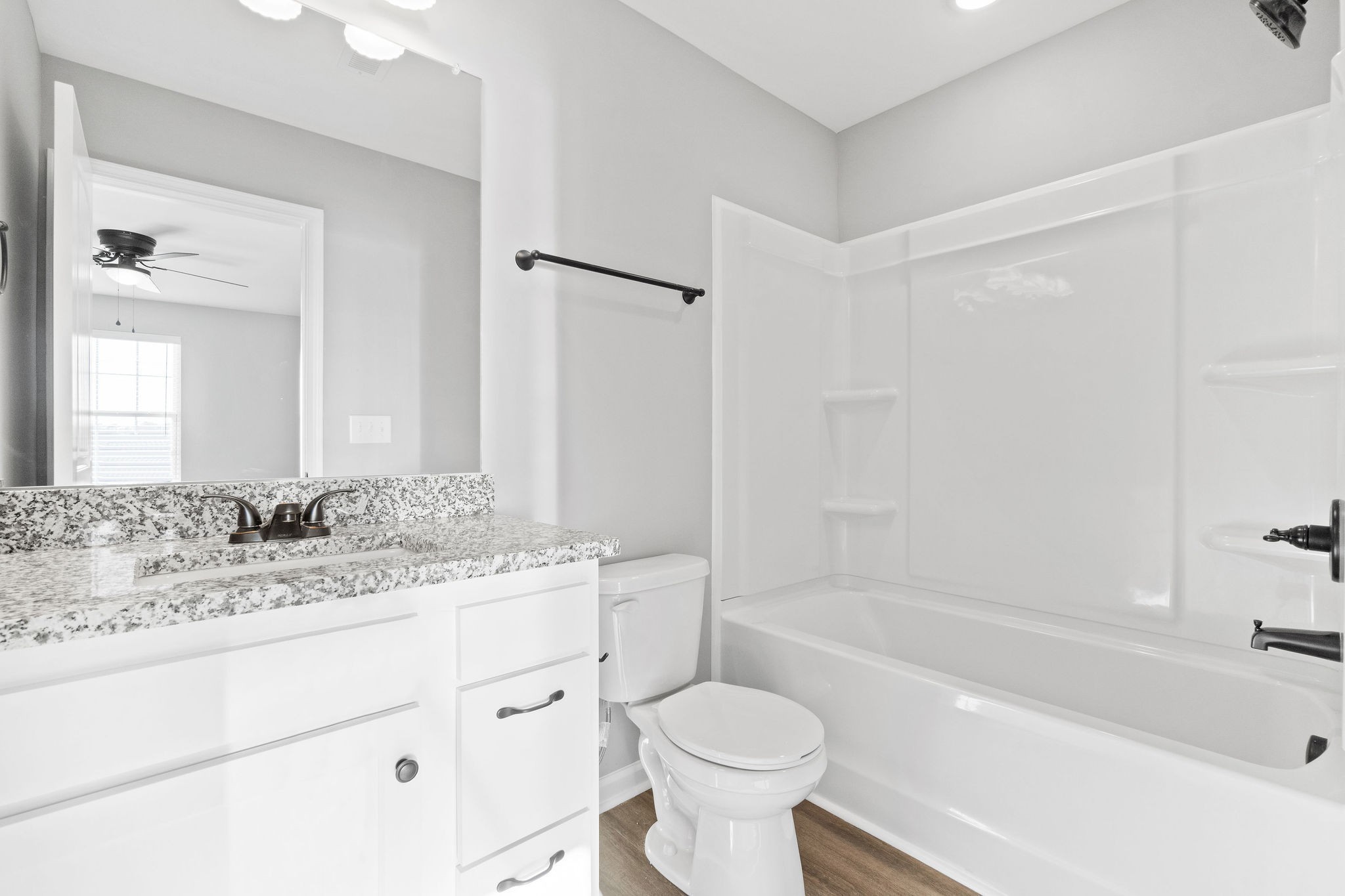2186 Peachers Mill Road, Unit C5 Clarksville, TN 37042 - Photo 13 of 15 a bathroom with a granite countertop sink toilet mirror and bathtub