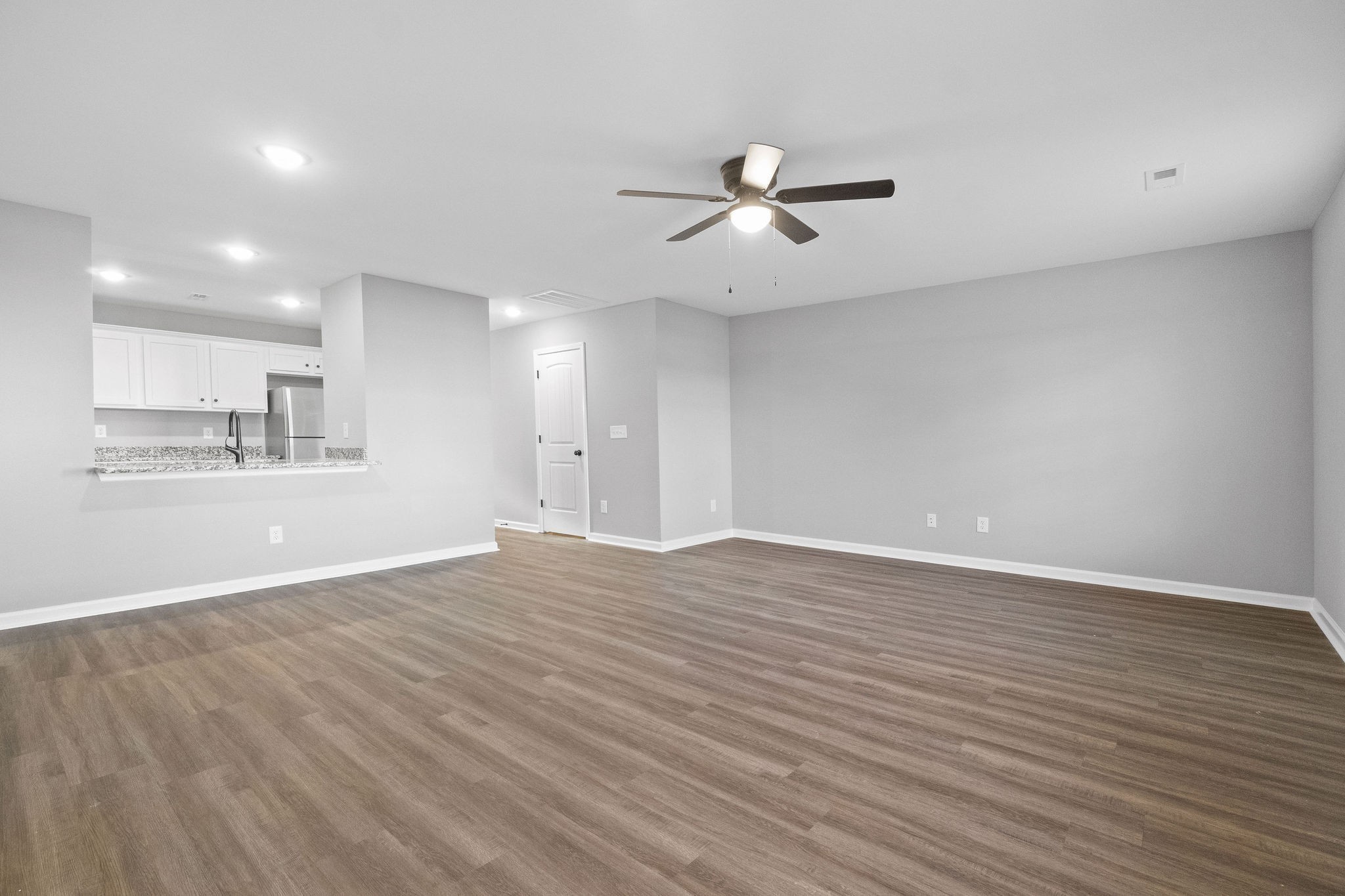 2186 Peachers Mill Road, Unit C5 Clarksville, TN 37042 - Photo 4 of 15 a view of an empty room with wooden floor and a kitchen