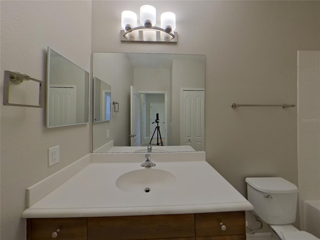Undisclosed Address Parrish, FL 34219 - Photo 13 of 16 a bathroom with a sink a toilet and mirror