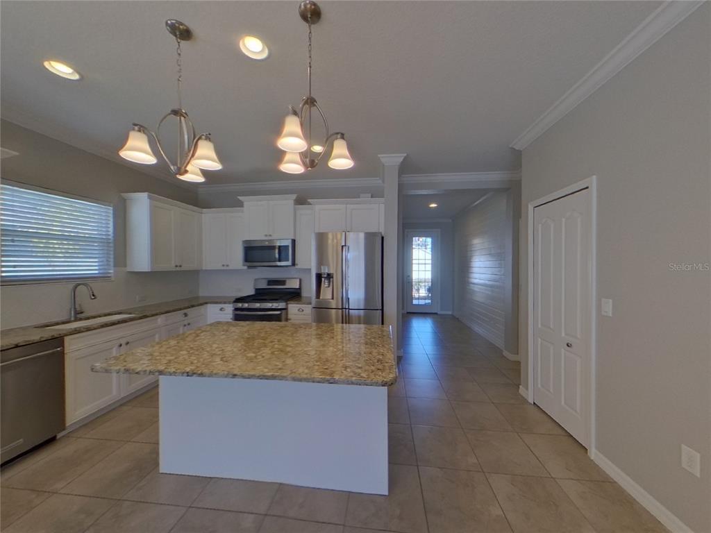 Undisclosed Address Parrish, FL 34219 - Photo 5 of 16 a view of a living room and kitchen with a decorative lights