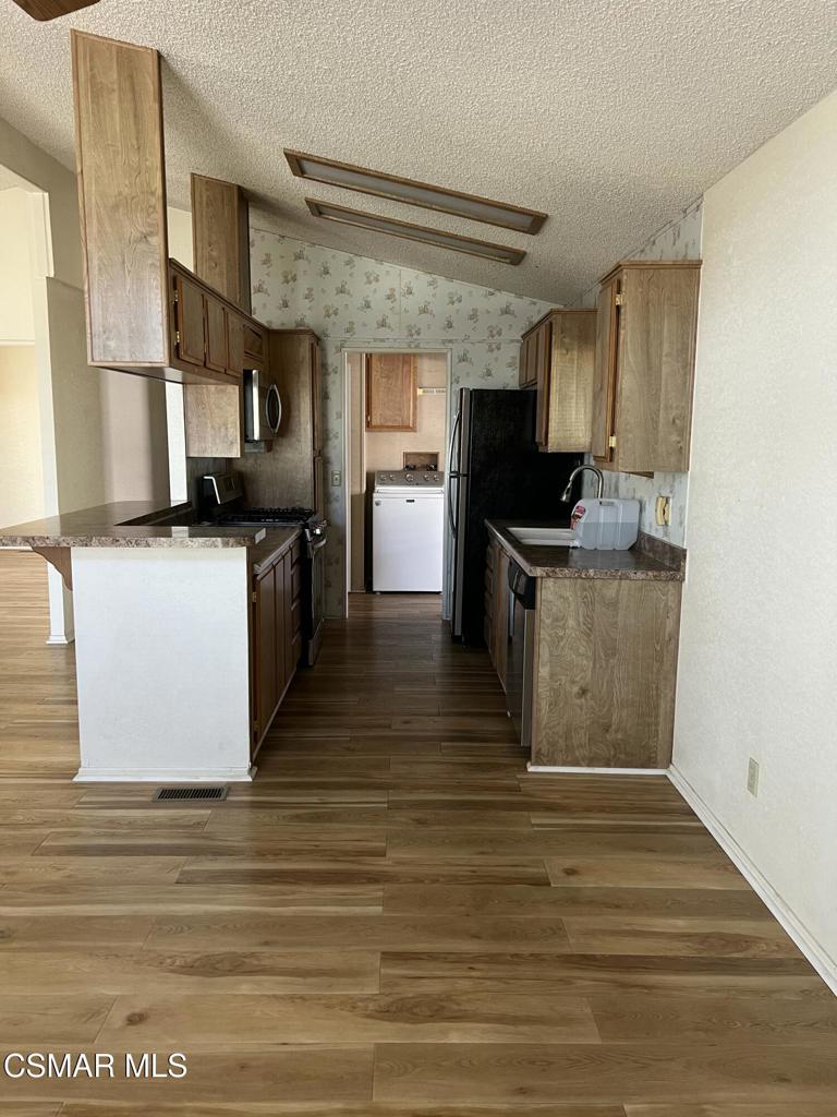 122 Don Felipe, Unit 122 Ojai, CA 93023 - Photo 11 of 50 a kitchen with stainless steel appliances granite countertop a stove a sink and a refrigerator
