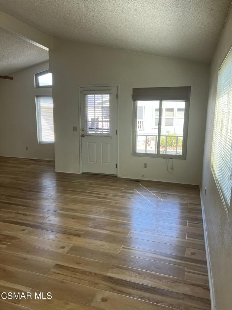 122 Don Felipe, Unit 122 Ojai, CA 93023 - Photo 12 of 50 an empty room with wooden floor and windows