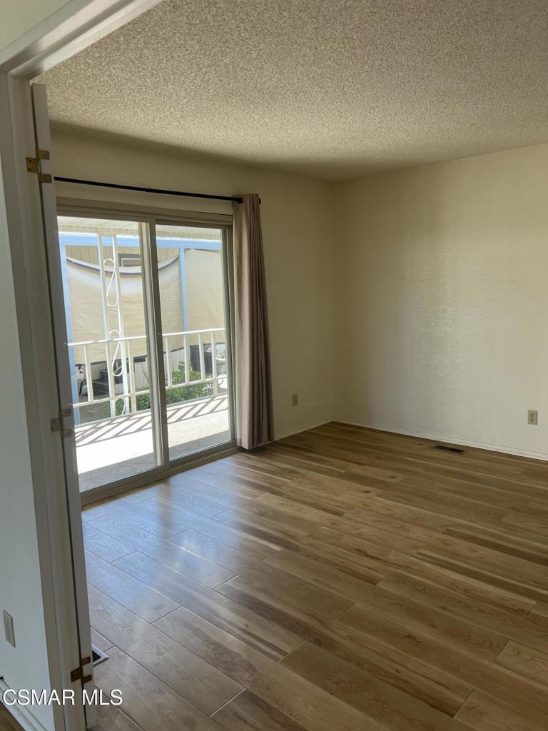 122 Don Felipe, Unit 122 Ojai, CA 93023 - Photo 14 of 50 an empty room with wooden floor and windows