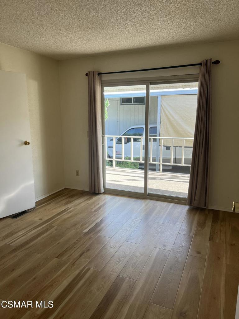 122 Don Felipe, Unit 122 Ojai, CA 93023 - Photo 16 of 50 a view of an empty room with wooden floor and a window