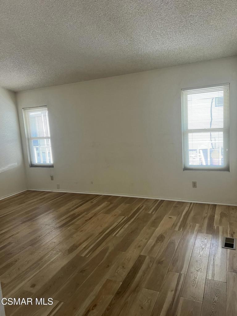 122 Don Felipe, Unit 122 Ojai, CA 93023 - Photo 19 of 50 an empty room with wooden floor and windows