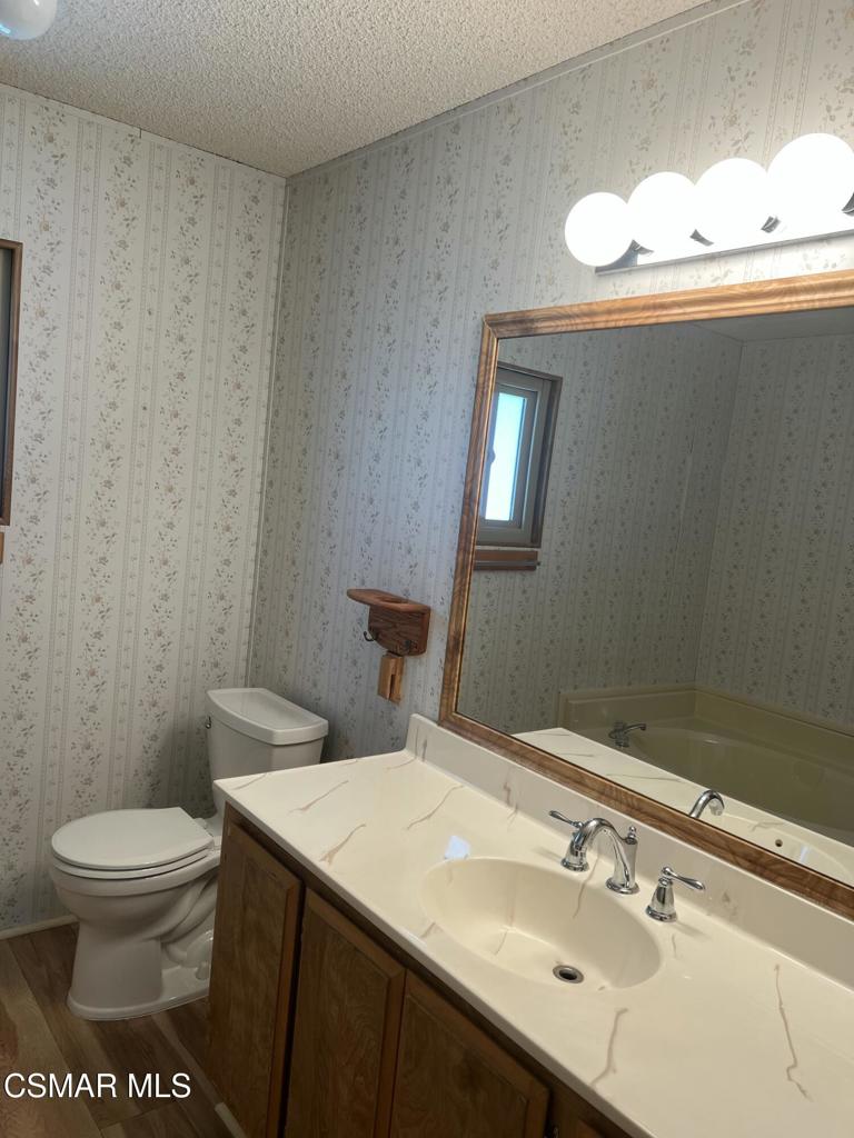 122 Don Felipe, Unit 122 Ojai, CA 93023 - Photo 20 of 50 a bathroom with a sink mirror and toilet