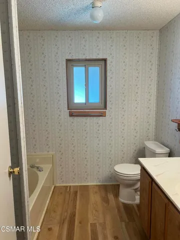 a bathroom with a toilet a sink and a shower