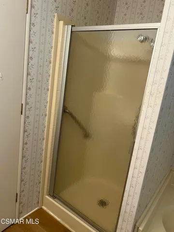 a bathroom with a glass shower door