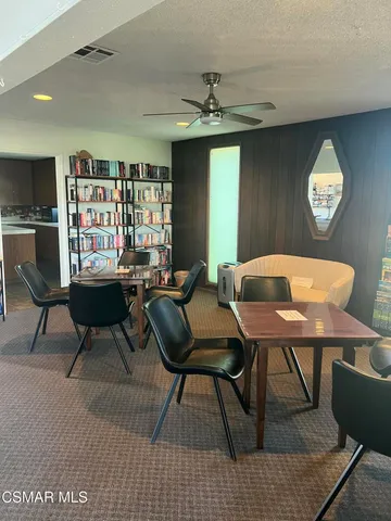 a living room with furniture and a piano