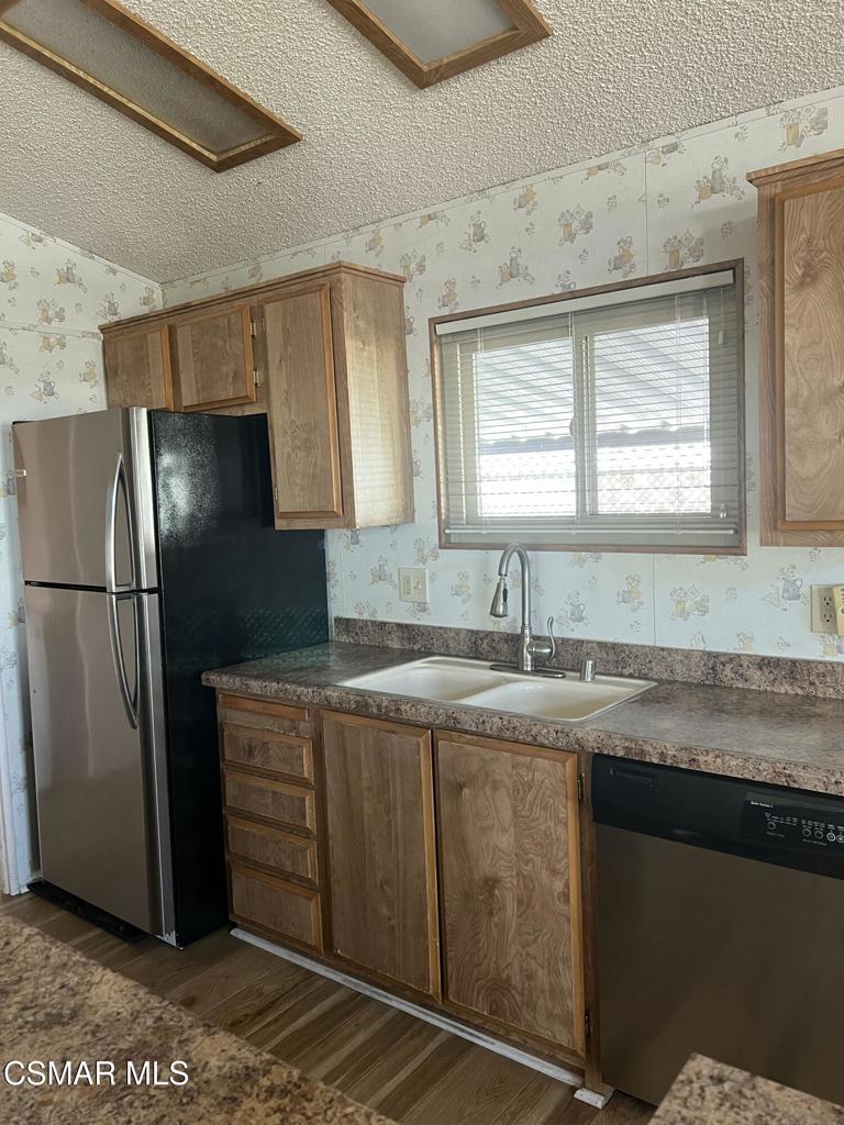 122 Don Felipe, Unit 122 Ojai, CA 93023 - Photo 5 of 50 a kitchen with stainless steel appliances granite countertop a refrigerator and a sink