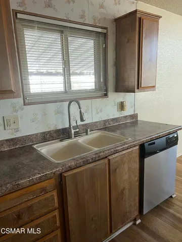 a view with granite countertop a sink and a window