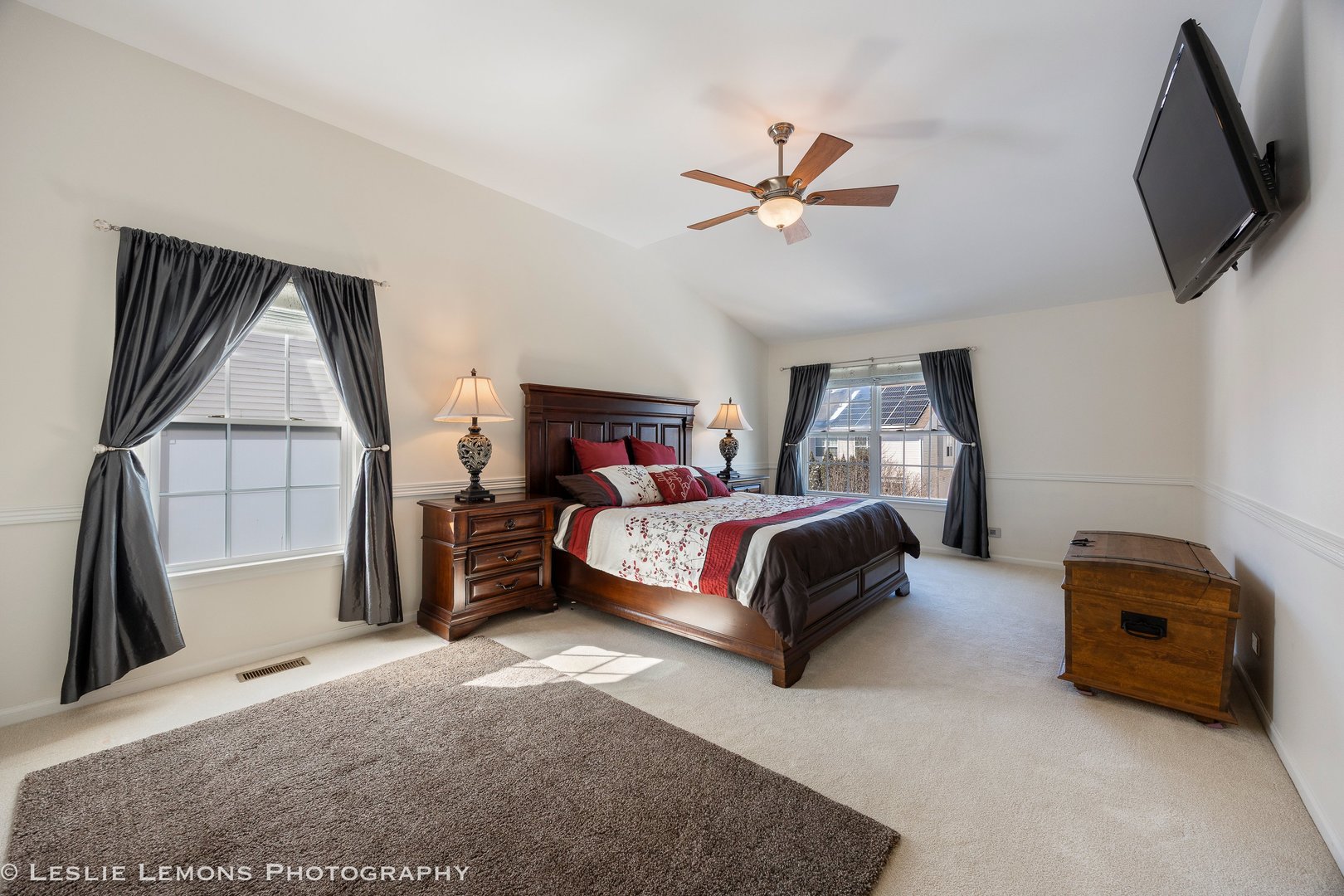 526 Windett Lane Geneva, IL 60134 - Photo 13 of 38 a bedroom with a bed a flat screen tv and a couch