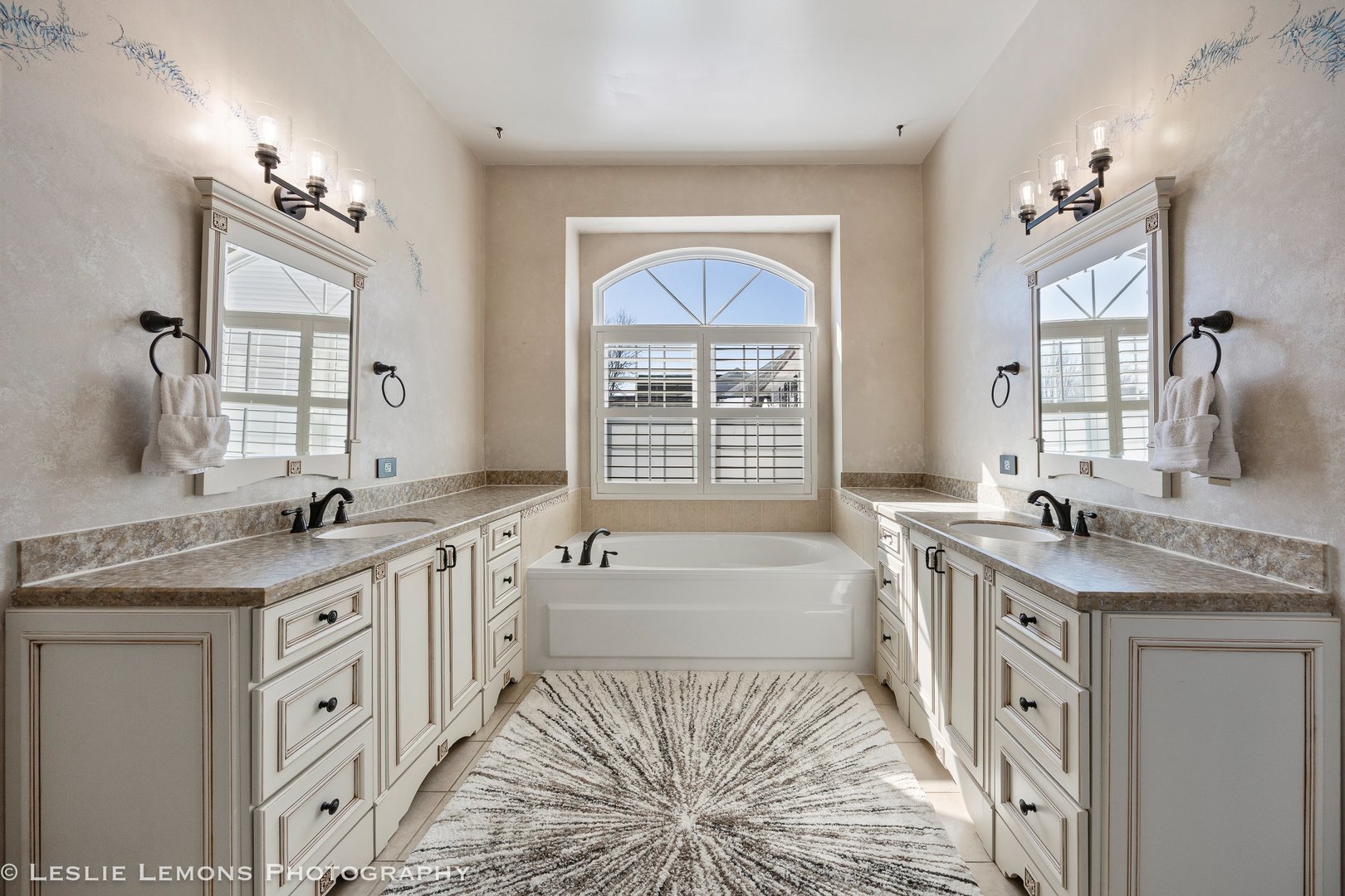 526 Windett Lane Geneva, IL 60134 - Photo 16 of 38 a spacious bathroom with a granite countertop sink a large mirror a bathtub and next to a window