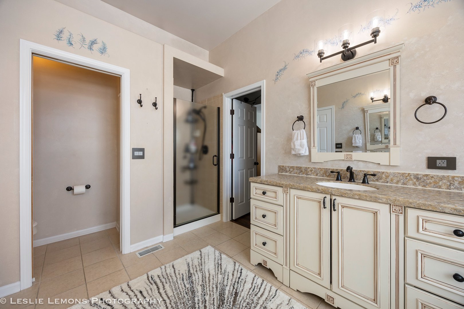 526 Windett Lane Geneva, IL 60134 - Photo 17 of 38 a spacious bathroom with a granite countertop sink mirror and a shower