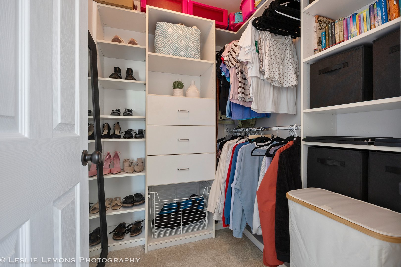 526 Windett Lane Geneva, IL 60134 - Photo 20 of 38 a view of walk in closet with clothes and shoes