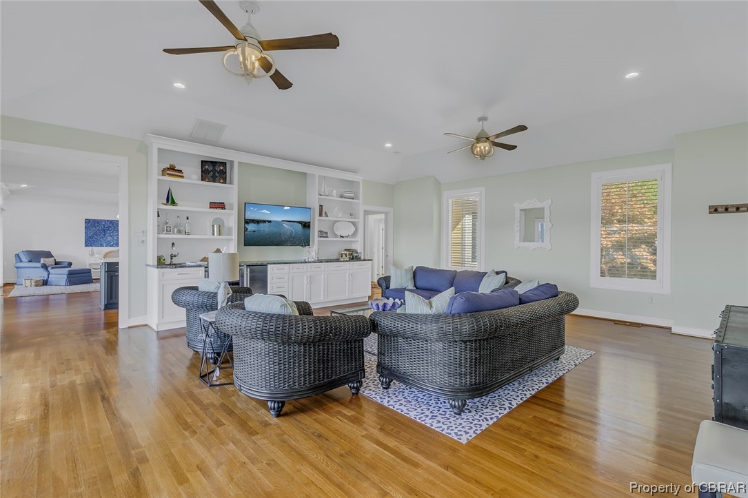 192 Bayberry Point Lane Kilmarnock, VA 22482 - Photo 28 of 49 Hardwood floored living room with built in shelves and ceiling fan