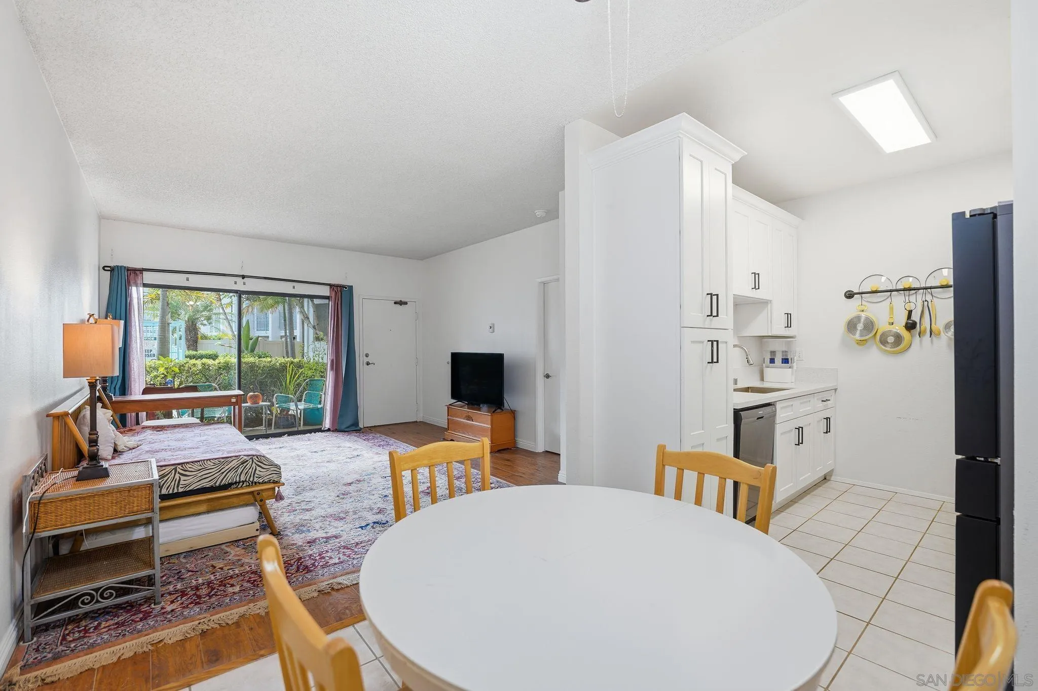 8310 Regents Road, Unit 1E San Diego, CA 92122 - Photo 12 of 28 a living room with furniture a fireplace and a large window
