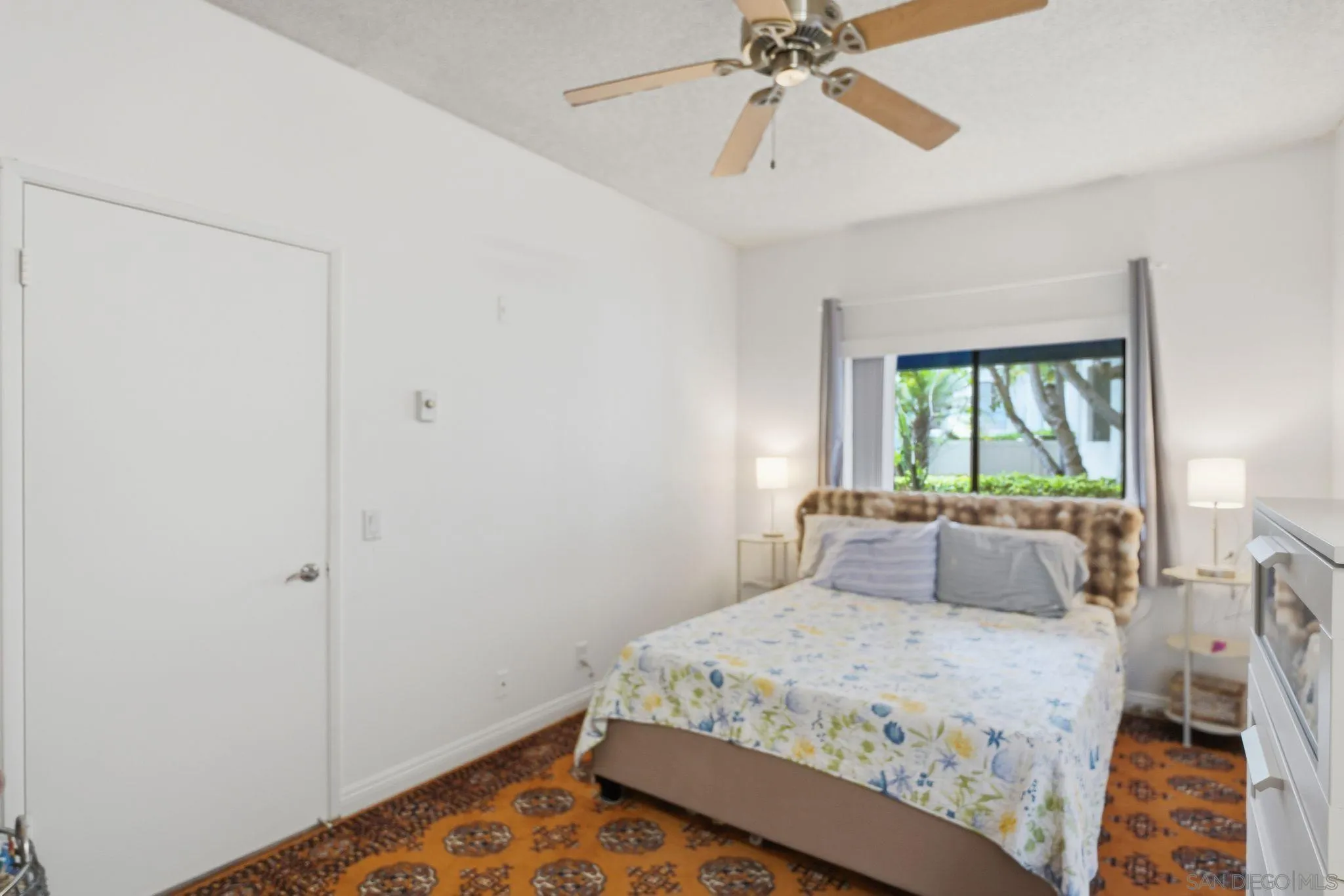8310 Regents Road, Unit 1E San Diego, CA 92122 - Photo 13 of 28 a bedroom with a bed and a chandelier