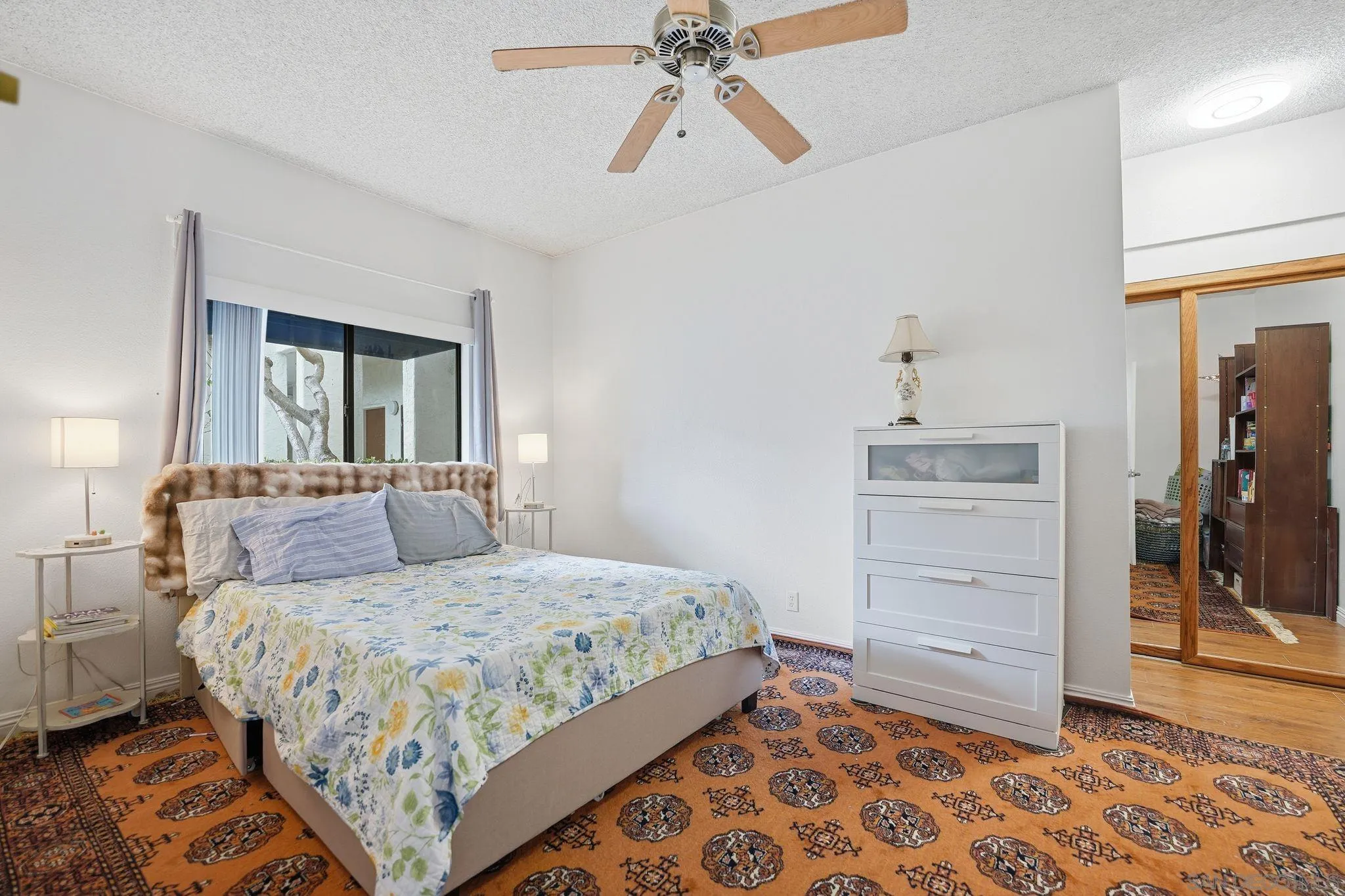 8310 Regents Road, Unit 1E San Diego, CA 92122 - Photo 14 of 28 a bedroom with a bed and a chandelier