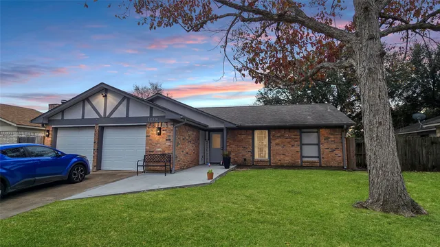 a front view of a house with a garden and yard