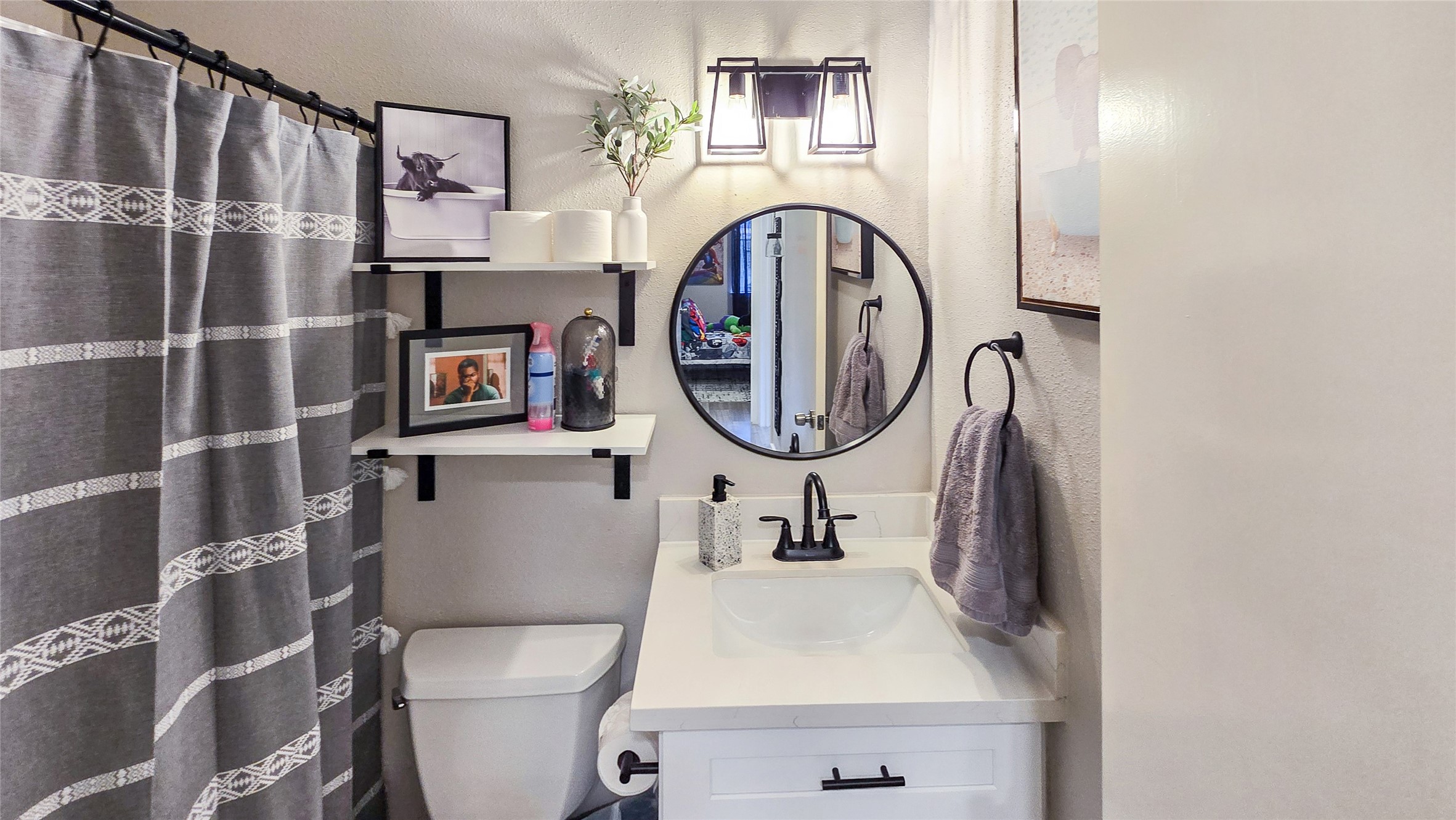 22531 John Rolfe Lane Katy, TX 77449 - Photo 17 of 19 a bathroom with a sink a mirror and a toilet