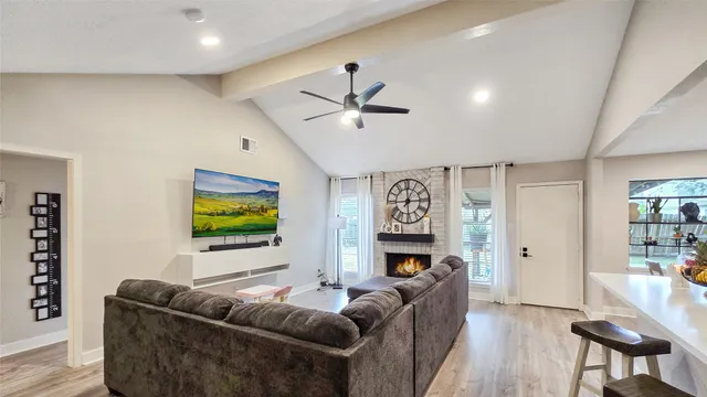 a living room with fireplace furniture and a flat screen tv