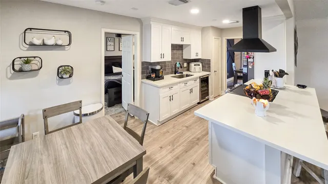 a kitchen with a sink appliances and cabinets