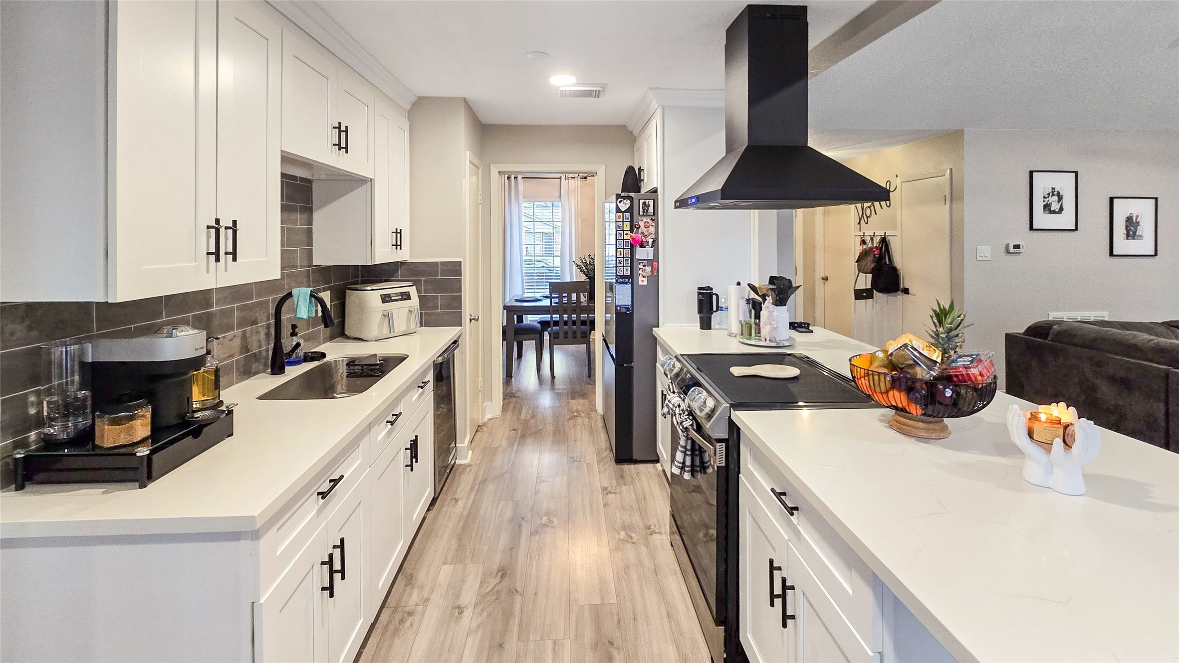 22531 John Rolfe Lane Katy, TX 77449 - Photo 9 of 19 a kitchen with a sink stove and wooden floor